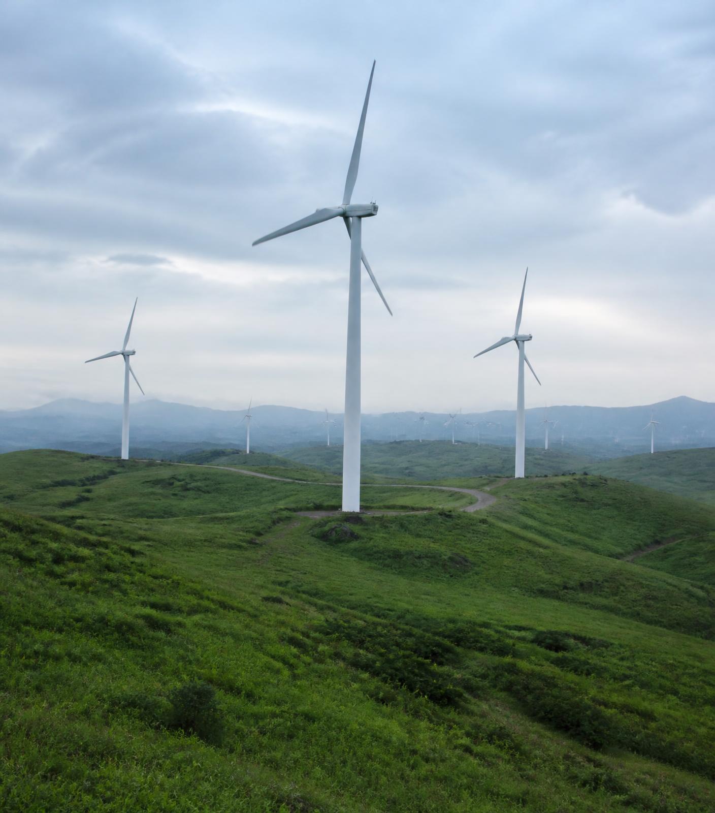Wind farm across green hills